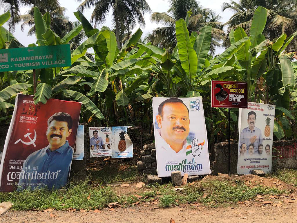 Hoardings in a Kerala village outside Cochin. Along with the Left and Congress candidates, note the hoarding of the candidate of the TwentyTwenty party, a new outfit floated by the Kitex company, whose symbol is -- what else, the pineapple |Photo: Jyoti Malhotra | ThePrint