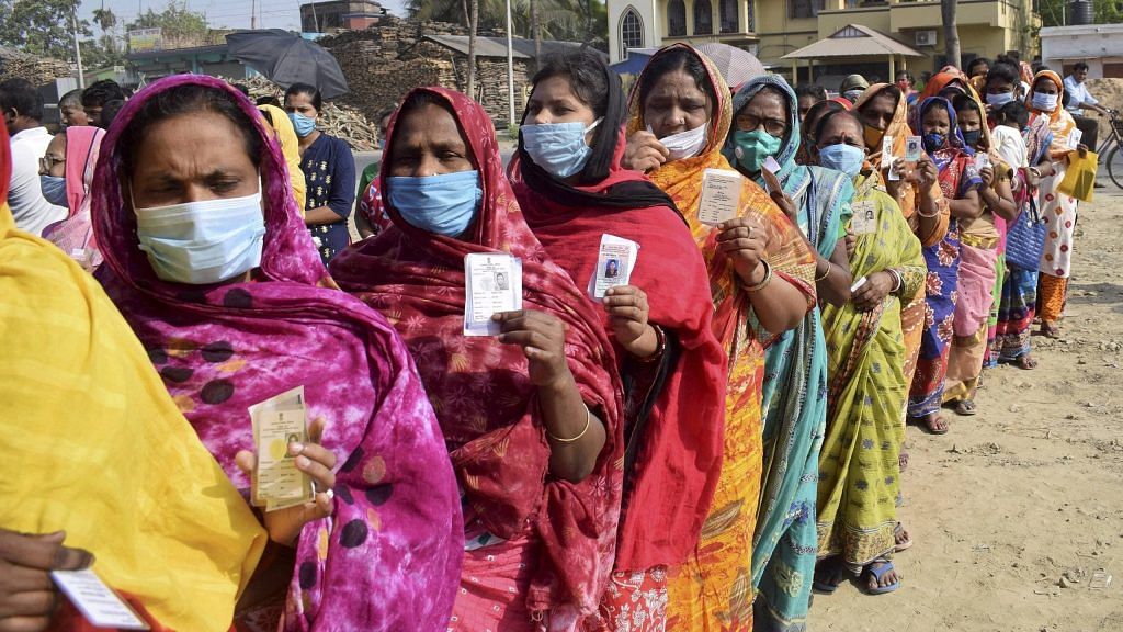 Women stand in a queue to cast their vote at a polling station during the 5th phase of State Assembly elections at Santipur, in Nadia | PTI