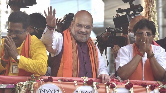 Union Home Minister Amit Shah during a roadshow in support of BJP candidates ahead of the 3rd phase of West Bengal Assembly polls at Baruipur Paschim in South 24 Parganas, on 2 April 2021 | PTI