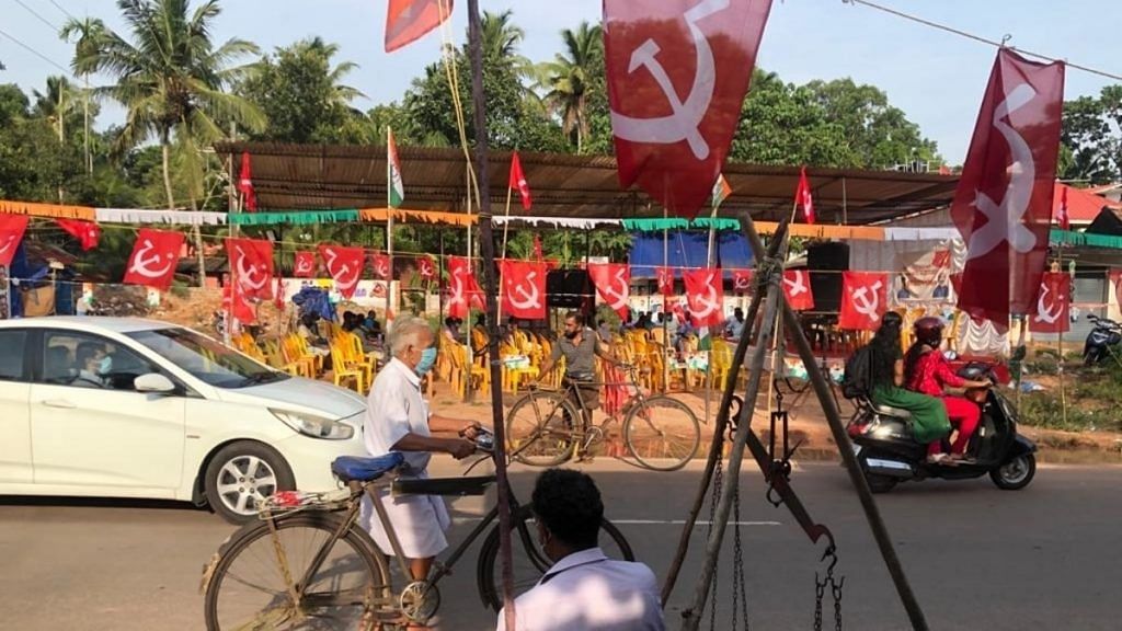 CPM flags flutter in Choonadu village ahead of Kerala Finance Minister Thomas Isaac's address at a roadside meeting. | Photo: Jyoti Malhotra/ThePrint