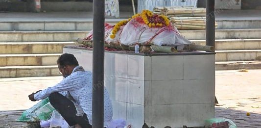 A man waits for his turn to cremate a relative at the Ellisbridge crematorium in Ahmedabad | Praveen Jain | ThePrint