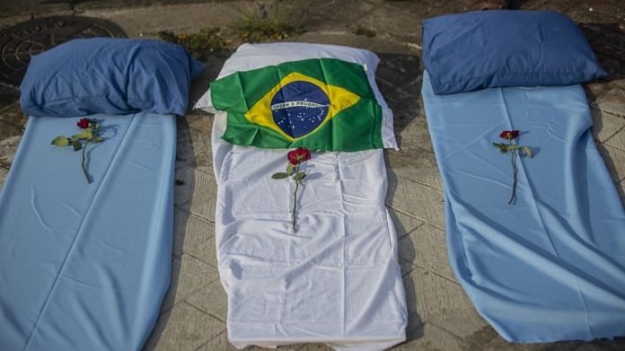 Flowers on blankets arranged to resemble gurneys during a protest against the government's pandemic response outside of the Raul Gazzola hospital in Rio de Janeiro, Brazil, on 24 March 2021 | Photographer: Dado Galdieri | Bloomberg