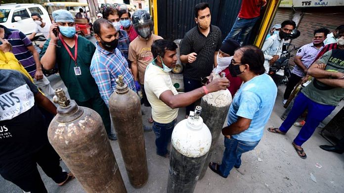 People in New Delhi enquire about availability of cylinders of medical oxygen, required for treatment of critical Covid-19 patients, as coronavirus cases surge across the country, on 21 April 2021 | Kamal Kishore | PTI