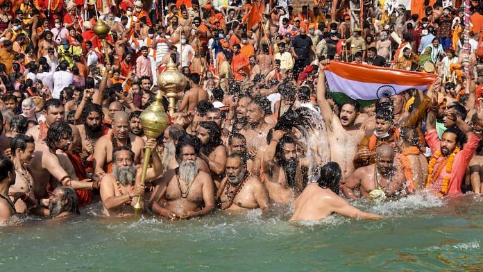 Devotees gather to offer prayers during the third 'Shahi Snan' of the Kumbh Mela 2021, in Haridwar, 14 April 2021 | PTI