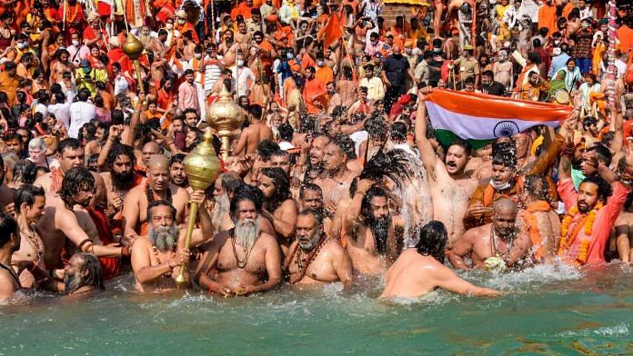 Devotees gather to offer prayers during the third Shahi Snan of the Kumbh Mela 2021, at Har ki Pauri Ghat in Haridwar on 14 April | PTI