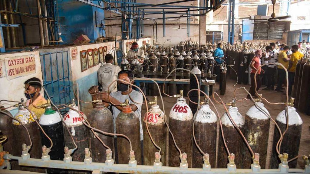 Workers refill cylinders with medical oxygen, in Patna, on 27 April 2021 | PTI