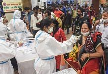 Health workers conduct Covid-19 testing of passengers arriving from Maharashtra at Patna Railway Station, as coronavirus cases surge across the country, in Patna, on 13 April 2021 | PTI