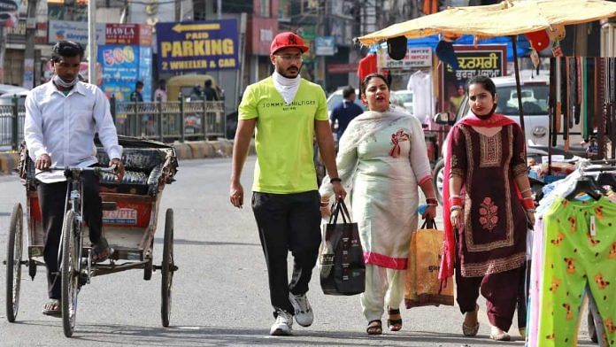 People walk near a market without wearing masks in Jalandhar, Punjab | Manisha Mondal | ThePrint