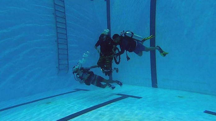 Man in wheelchair (centre) trains for scuba diving with CLAW | Photo by special arrangement