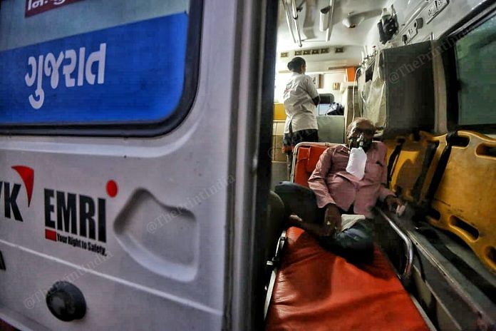 Patient wearing oxygen masks inside the ambulance | Photo: Praveen Jain | ThePrint