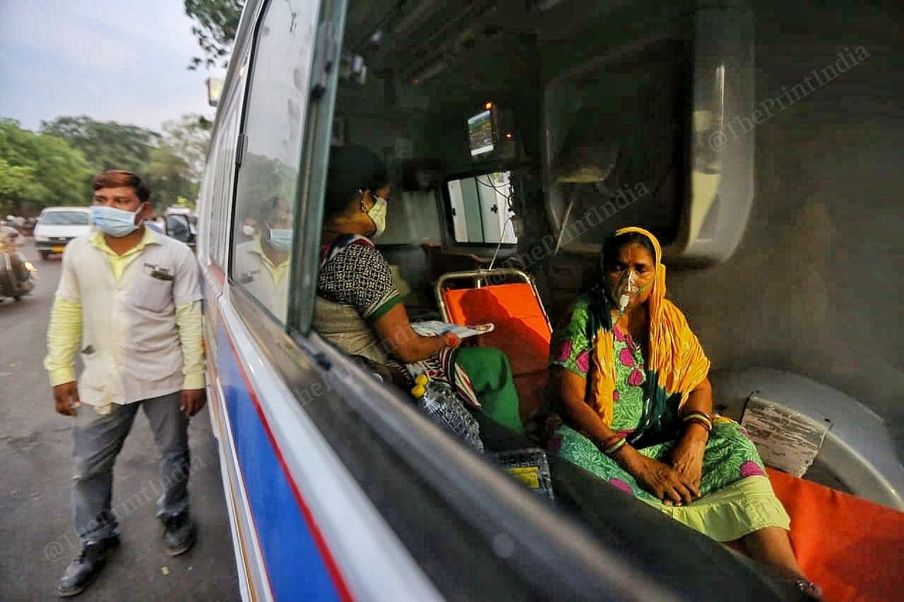 Women wearing oxygen masks inside the ambulance | Photo: Praveen Jain | ThePrint