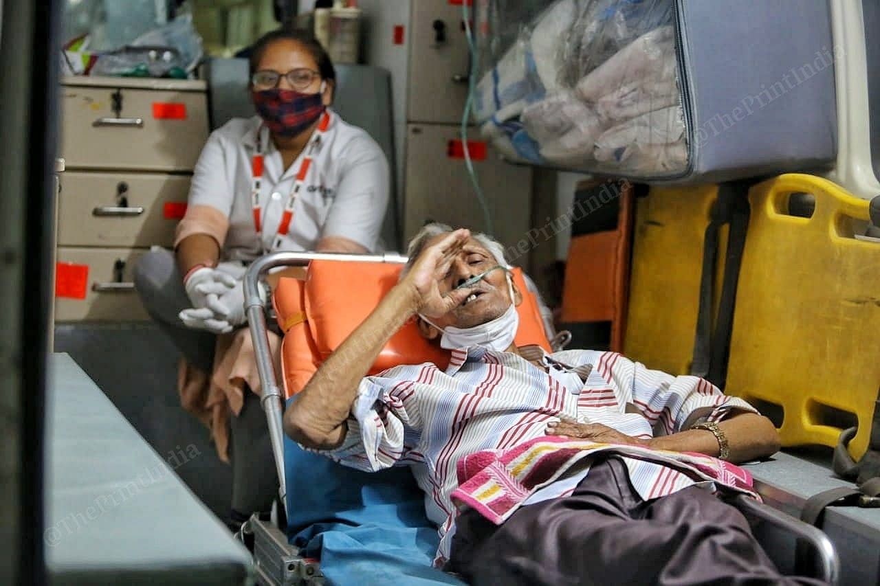 An old man feels sick inside the ambulance | Photo: Praveen Jain | ThePrint