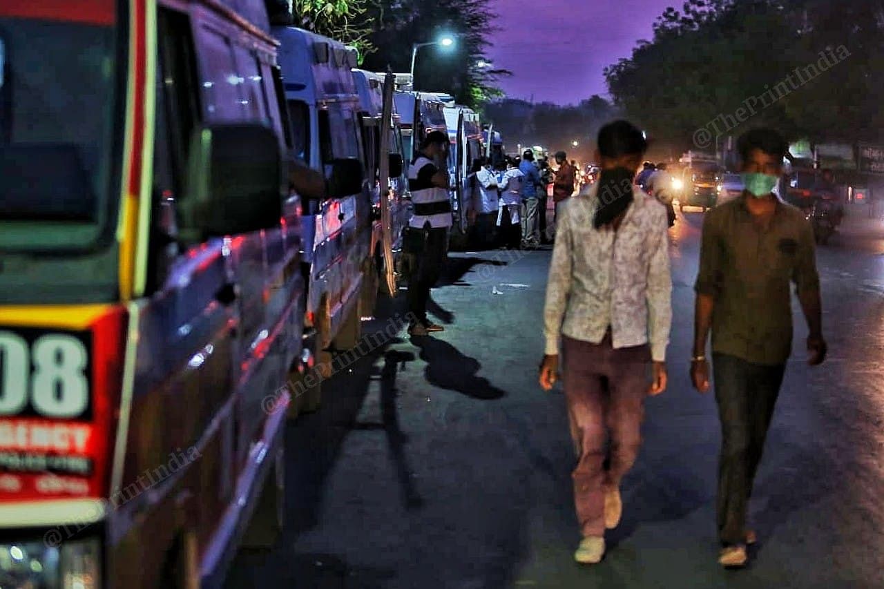 As day turns into night, the line of ambulances only grows longer as new and increased number of ambulances come in to replace the older ones. | Photo: Praveen Jain | ThePrint