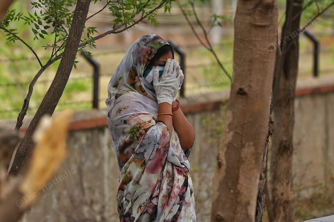 Relatives of Covid-19 victims reacts during the funeral pyre | Photo: Suraj Singh Bisht | ThePrint