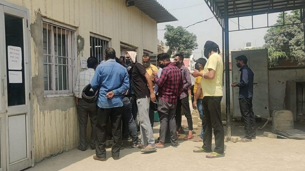 People crowd around a single window for Covid test reports at Mukand Lal Civil Hospital in Yamunanagar | Photo: Urjita Bhardwaj | ThePrint
