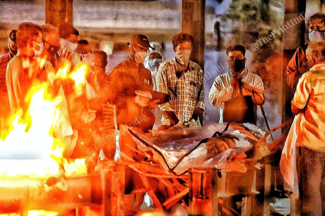 One burns while the other waits for his turn, as bodies queue up the wait can last as long as 3 hours at Ellisbridge crematorium | Photo: Praveen Jain | ThePrint