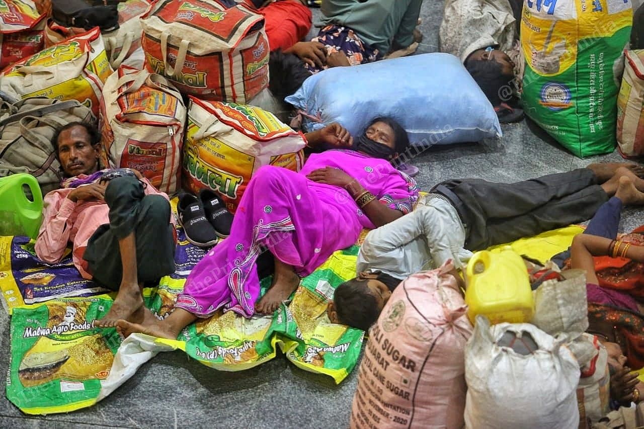 A woman rests with her family in Ahmedabad railway station | Photo: Praveen Jain | ThePrint
