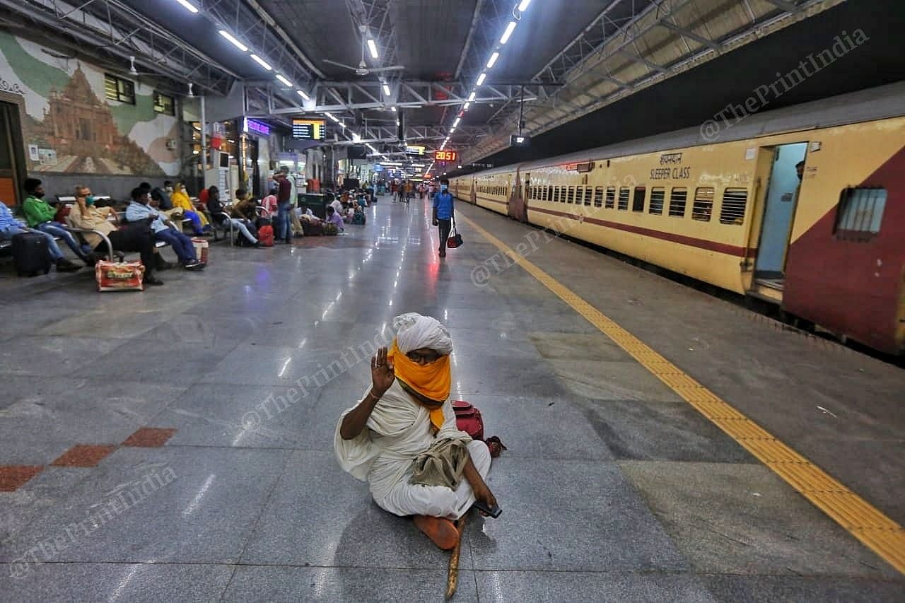 A passenger waits at the platform in the night | Photo: Praveen Jain | ThePrint
