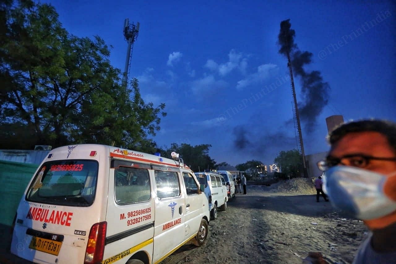 Ambulances queue up outside outside the Juna vadaj crematorium as chimneys bellow smoke | Photo: Praveen Jain | ThePrint
