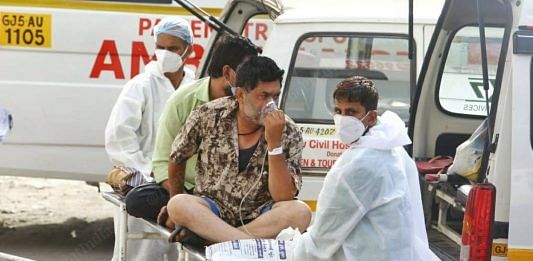 A Covid patient is offered medical support outside the New Civil Hospital of Surat | Soniya Agrawal | ThePrint