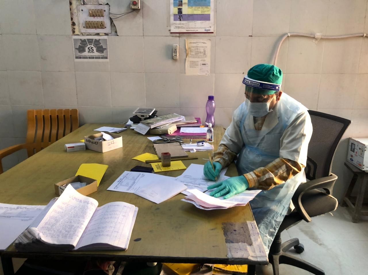 A doctor records patient symptoms near the emergency ward at Jaunpur district hospital | Jyoti Yadav | ThePrint