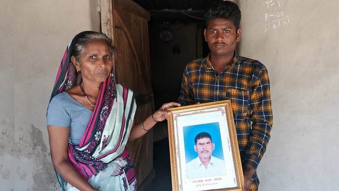 Savita Jadhav and her son Shubham Jadhav hold up a photograph of Shyam Jadhav who committed suicide | Photo: Angana Chakrabarti | ThePrint