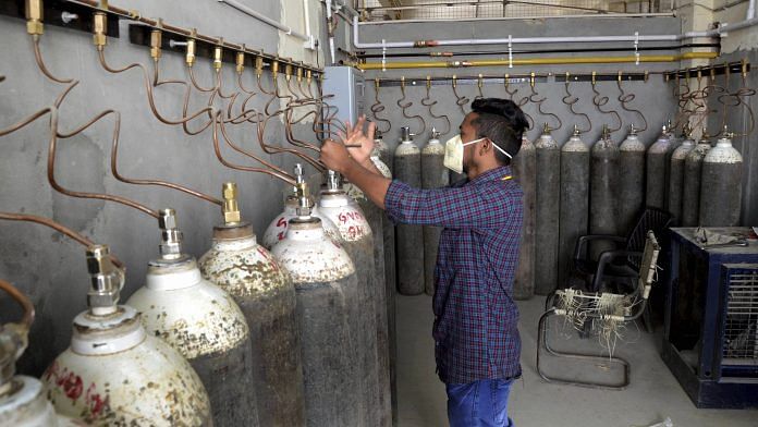 A technician filling oxygen cylinders at Guru Nanak Dev hospital in Amritsar on 24 April 2021 | PTI Photo