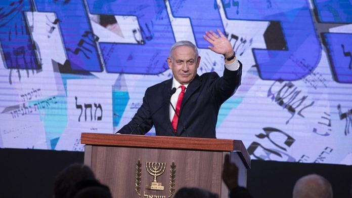 Benjamin Netanyahu, Israel's prime minister and the leader of the Likud party, waves to his supporters on stage during a party event in Jerusalem, on 24 March 2021 | Photographer: Kobi Wolf | Bloomberg
