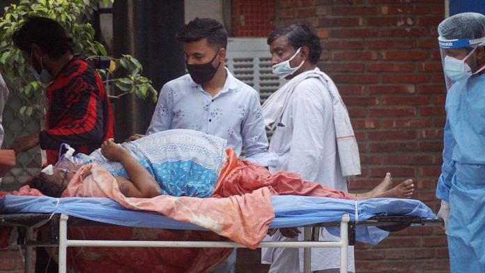 A Covid patient being carried on a stretcher outside a hospital, in New Delhi, on 11 April 2021
