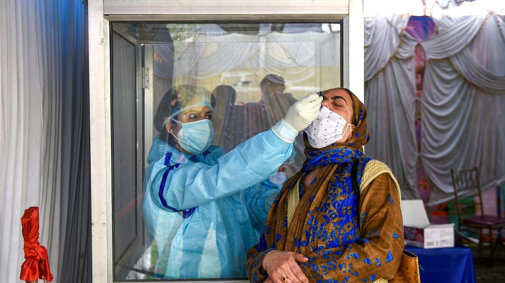 A health worker conducts Covid-19 test in Srinagar on 6 April 2021 | PTI Photo