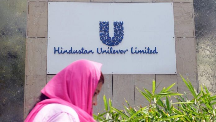 A pedestrian walks past the logo of Hindustan Unilever Limited outside its office in Mumbai | Representational image | Photographer: Indranil Mukherjee/AFP/Getty Images via Bloomberg