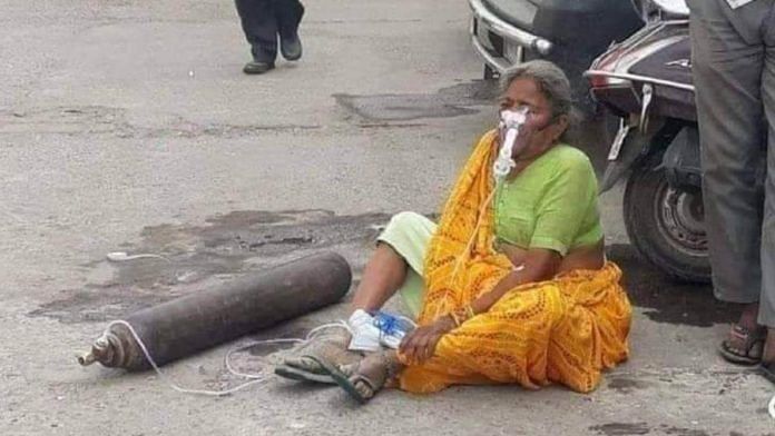 Viral photo of woman on road with oxygen cylinder not recent