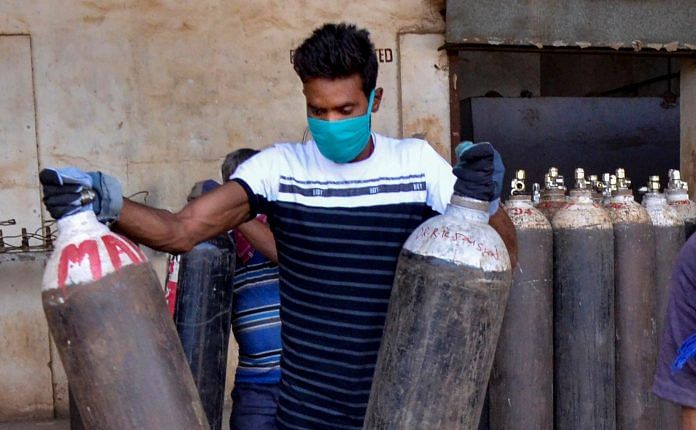 A worker arranging oxygen cylinders to be delivered to hospitals for Covid-19 patients, in Ranchi on 19 April 2021