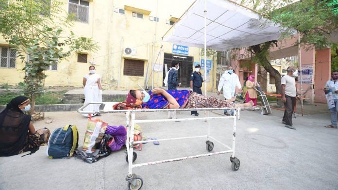 A patient lies on a stretcher as she waits for a bed at Bhilwara's MG hospital | Rohit Jain Paras | ThePrint