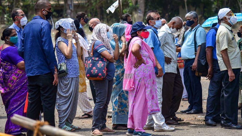Representational Image | People wait in a queue to receive a dose of Covid-19 vaccine in Mumbai, on 26 April 2021 | PTI