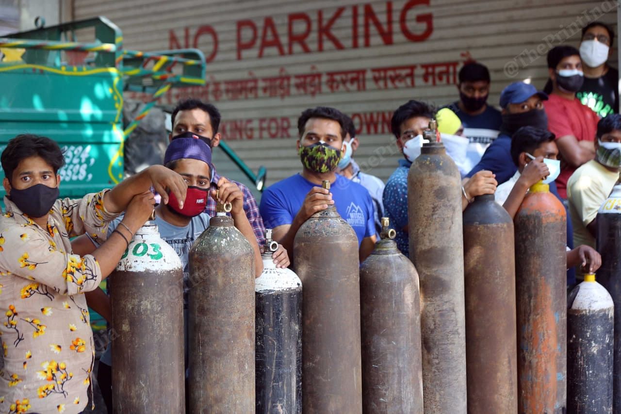 People stood in queues since morning to get oxygen cylinder filled for their family members. This shop is Bhogal witnesses huge rush, and the crowd still continues | Suraj Singh Bisht | ThePrint