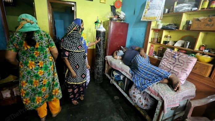 Shahulla Khan, 45, and his family at their home on 12 May, waiting for an oxygen bed in a government hospital. | Photo: Praveen Jain/ThePrint