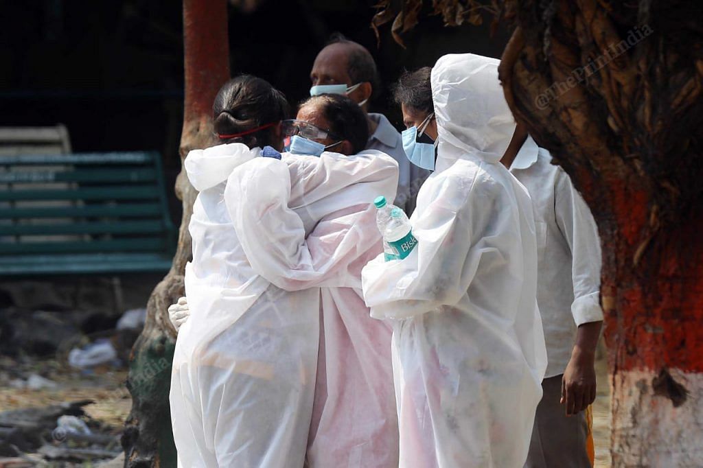 A common visual outside mortuary, hospitals and crematoriums. Family members holding each other, trying to cope with the pain | Suraj Singh Bisht | ThePrint