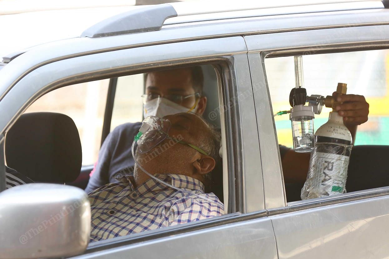 Delhi's LNJP has been busiest since the beginning of pandemic. But this time it was overburdened, with patients in ambulances standing in queue, waiting to get a bed in the covid ward. This patient sitting with support of oxygen, was waiting in the car to get a bed | Suraj Singh Bisht | ThePrint