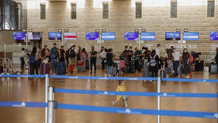 Passengers queue to check-in for a flight in the departures terminal at Ben Gurion International airport in Tel Aviv, Israel | Photographer: Kobi Wolf/Bloomberg