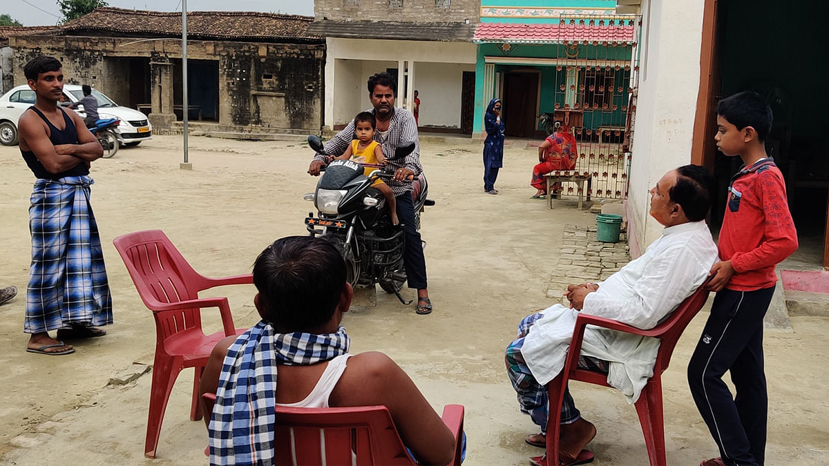 Abdul Qayoom (seated, in white shirt), a teacher in Mirzapur said the primary reason for vaccine hesitancy was illiteracy | Photo: Sajid Ali/ThePrint