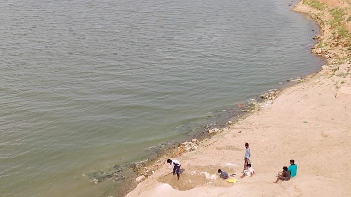 Labourers dig graves beside the Ganga in Gahmar, Ghazipur district, to dispose of hundreds of bodies floating down the river | Photo: Sajid Ali | ThePrint