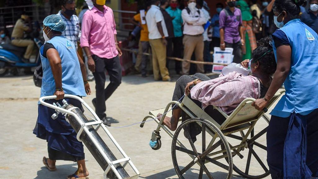 A patient being taken for CT scan with oxygen support at Government Kilpauk Medical College (GKMC) Hospital, in Chennai in April 2021 | PTI