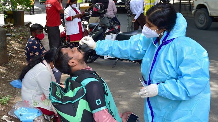 A medic collects samples from e-commerce and food delivery personnel for Covid-19 testing in Bengaluru, on 24 May 2021 | PTI