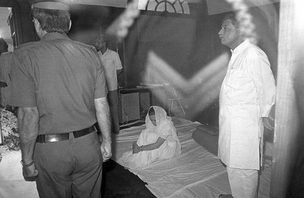 Sonia Gandhi sits by herself in mourning beside her husband’s last remains at Teen Murti House.