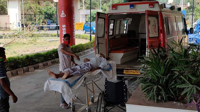 A person suffering from Covid is shifted to the isolation facility at the Rajiv Gandhi Cricket stadium in Dehradun | Taran Deol | ThePrint