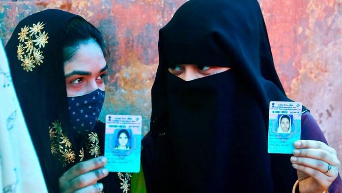 Muslim women voters Muslim voters show their voter IDs as they wait to cast their votes in the 5th phase of West Bengal Assembly election, in North 24 Parganas in April 2021 | ANI