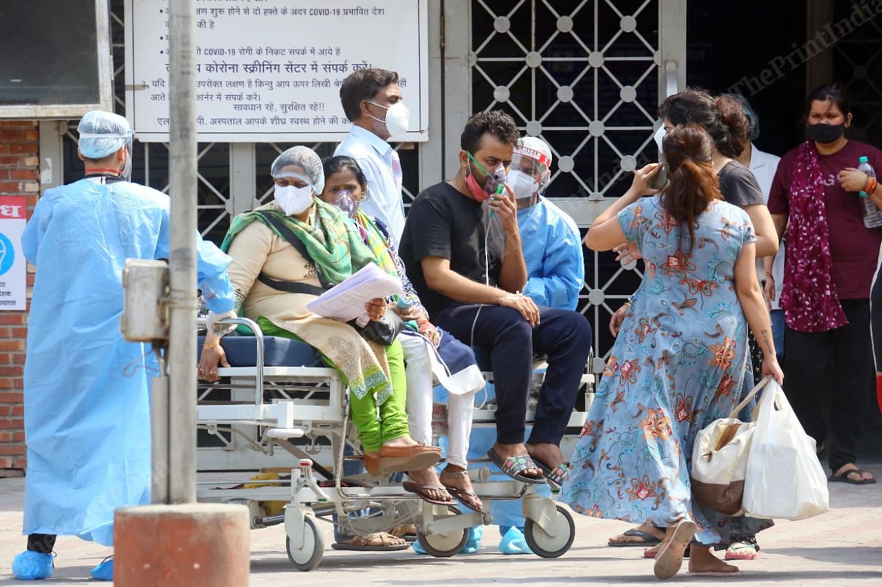 Families wait outside the gate of LNJP hospital | Praveen Jain | ThePrint