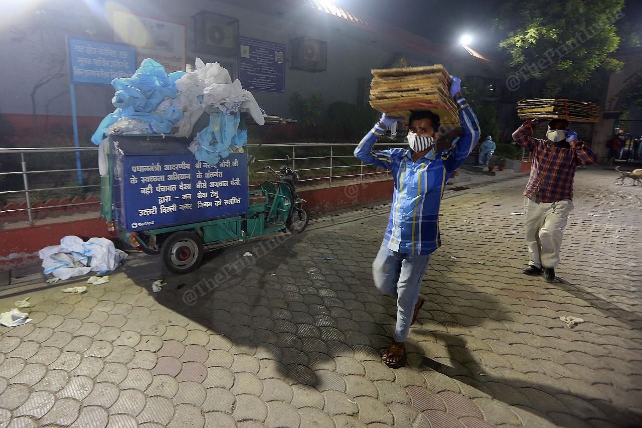 A dumpster full of PPE kits lies at the entrance of the Nigambodh Ghat crematorium | Praveen Jain | ThePrint