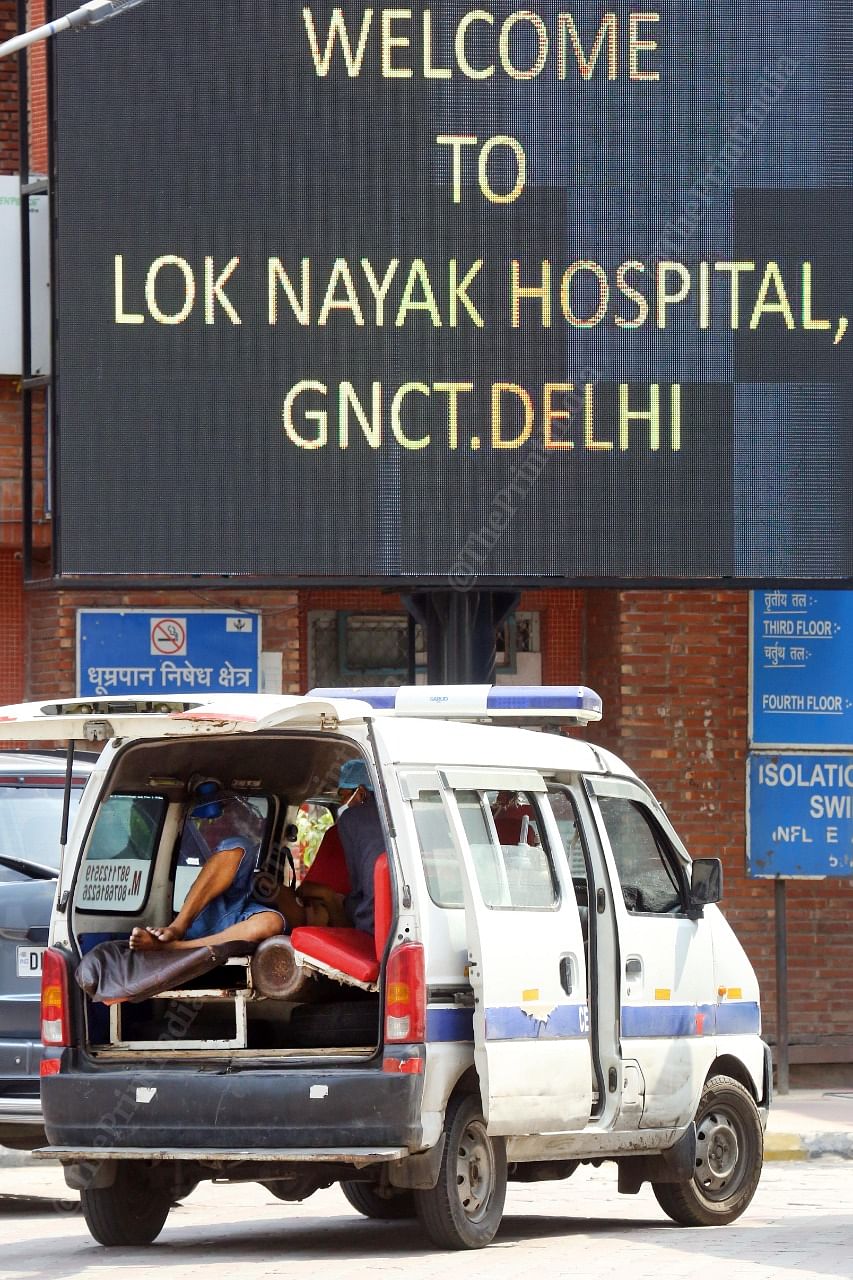 A patient lies in an ambulance van outside LNJP hospital | Praveen Jain | ThePrint.